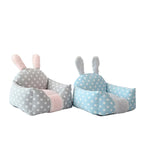 Two polka dot bunny-shaped cushions on a white background